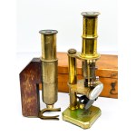 Two antique brass microscopes, one in a box