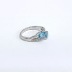 Silver ring with natural white and blue topazes
