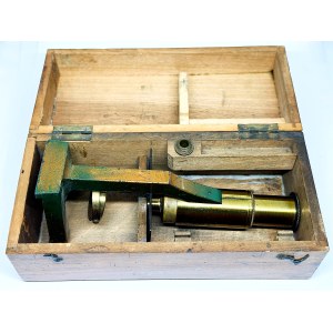 Antique travel microscope with a spare lens in a box