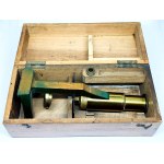 Antique travel microscope with a spare lens in a box
