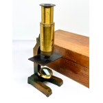 Antique travel microscope with a spare lens in a box