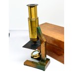 Antique travel microscope with a spare lens in a box
