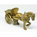 A brass figurine depicting a horse pulling a cart