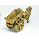 A brass figurine depicting a horse pulling a cart