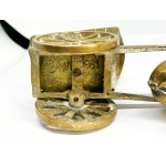A brass figurine depicting a horse pulling a cart