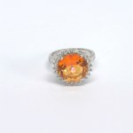 Silver ring with a natural Padparadscha topaz and white topazes