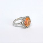 Silver ring with a natural Padparadscha topaz and white topazes