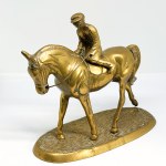 A brass statue depicting a rider on a horse