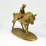 A brass statue depicting a rider on a horse