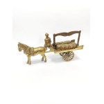A brass figurine depicting a coal merchant