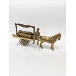 A brass figurine depicting a coal merchant