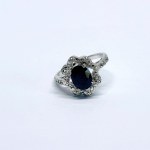 Silver ring with a natural dark-blue sapphire and white topaz