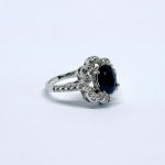 Silver ring with a natural dark-blue sapphire and white topaz