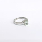 Silver ring with a natural prasiolite and white topazes