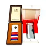 Two lighters—Marksman and WIN International—in boxes