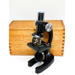 A small Japanese HOC microscope in a box with a glass slide