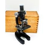 A small Japanese HOC microscope in a box with a glass slide