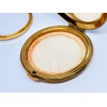 Gold-plated compact with a mirror