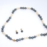 A gold set featuring freshwater pearl earrings and a necklace