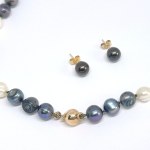A gold set featuring freshwater pearl earrings and a necklace