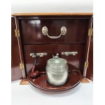 A portable luxury smoking set. Includes two ashtrays, a tobacco container, and a pipe. Mahogany, early 20th century