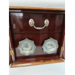 A portable luxury smoking set. Includes two ashtrays, a tobacco container, and a pipe. Mahogany, early 20th century