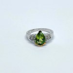 Silver ring with a natural peridot and white topaz