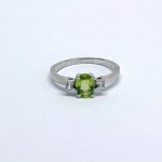 Silver ring with a natural peridot and white sapphires
