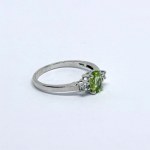 Silver ring with a natural peridot and white sapphires