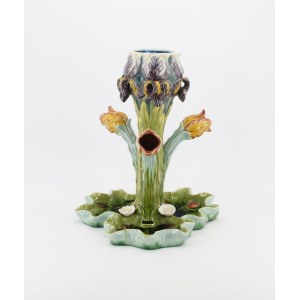 A flower vase shaped like flowers, with a leafy base