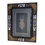 African-style mask in an ornate frame