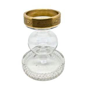 Vintage candlestick made of faceted glass with a gold rim