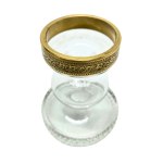 Vintage candlestick made of faceted glass with a gold rim