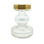 Vintage candlestick made of faceted glass with a gold rim