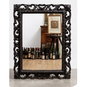Large wall mirror made of ebonized wood, perforated and decorated with scroll and foliage motifs, 84x67 cm