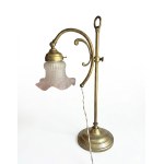 Adjustable Art Nouveau-style brass table lamp with a shaped glass shade