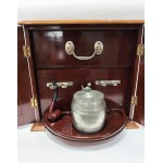 A portable, luxury smoking set. Includes two ashtrays, a tobacco container, and a pipe. Mahogany, early 20th century