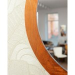 A large round wall mirror in a teak frame, from Denmark. 1970s/1980s.