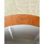 A large round wall mirror in a teak frame, from Denmark. 1970s/1980s.