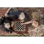 A polychrome porcelain sculptural group depicting checkers players
