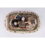 A polychrome porcelain sculptural group depicting checkers players