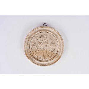 A circular plaster bas-relief depicting a warrior in armor with a heraldic coat of arms