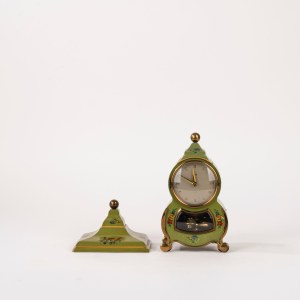 Small green Bakelite clock decorated with floral motifs