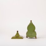 Small green Bakelite clock decorated with floral motifs