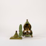 Small green Bakelite clock decorated with floral motifs
