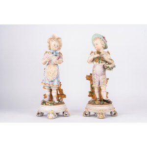 A pair of biscuit sculptures depicting a shepherd boy and a shepherdess