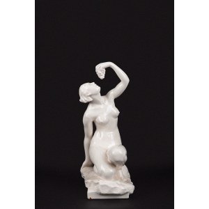 White porcelain sculpture depicting a nude woman holding a bunch of grapes