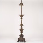 Bronze and brass candle holder with a lamp attached