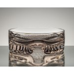 A bowl made of rose-patterned glass, with geometric decoration on the base, from the 1970s.