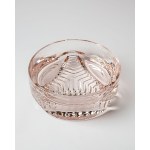 A bowl made of rose-patterned glass, with geometric decoration on the base, from the 1970s.